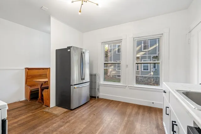 a kitchen with stainless steel appliances granite countertop a refrigerator and a stove top oven