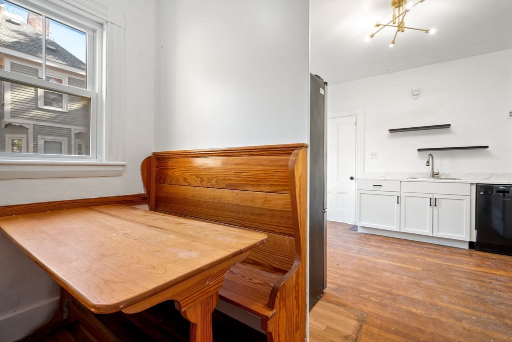 168 Elliot Street, Unit 1 Newton, MA 02464 - Photo 5 of 14 a view of kitchen and wooden floor