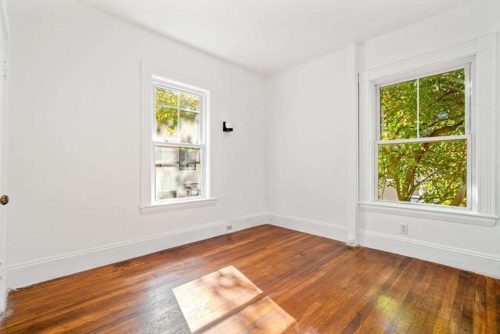 168 Elliot Street, Unit 1 Newton, MA 02464 - Photo 7 of 14 an empty room with a window