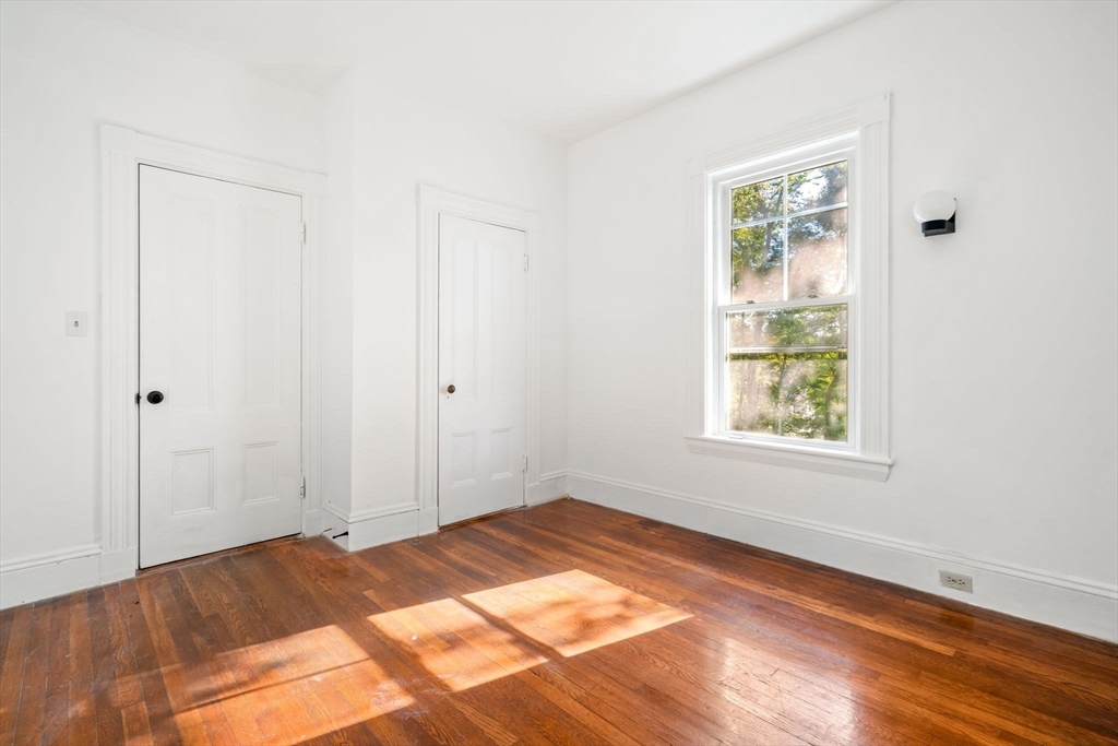 168 Elliot Street, Unit 1 Newton, MA 02464 - Photo 9 of 14 an empty room with window