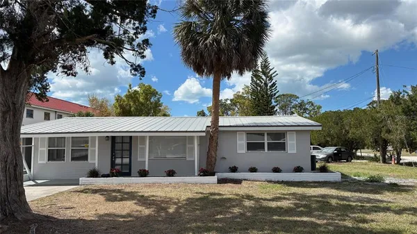 a front view of a house with a garden and yard