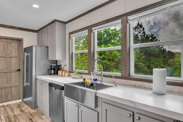 a kitchen with a sink and a refrigerator