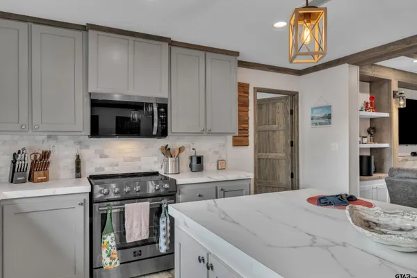 a kitchen with stainless steel appliances granite countertop a stove and a refrigerator