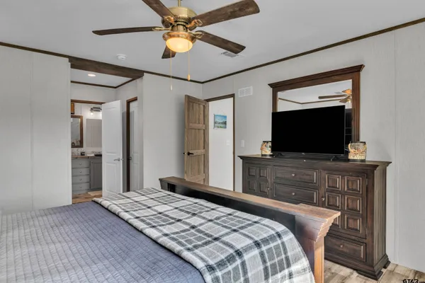 a bedroom with a bed and a flat screen tv