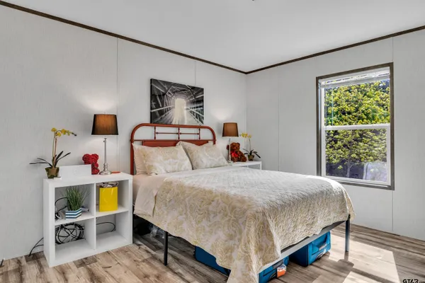 a bedroom with a bed a couch and a window