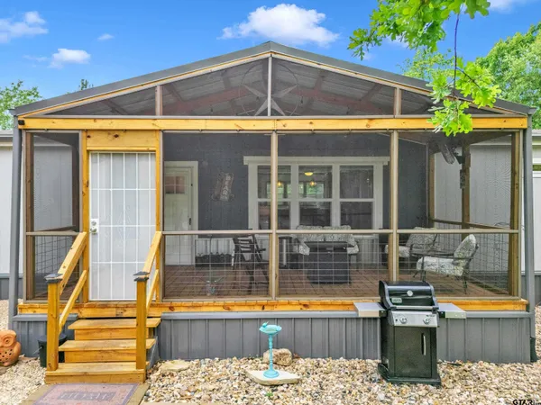 a view of a house with pool and sitting area