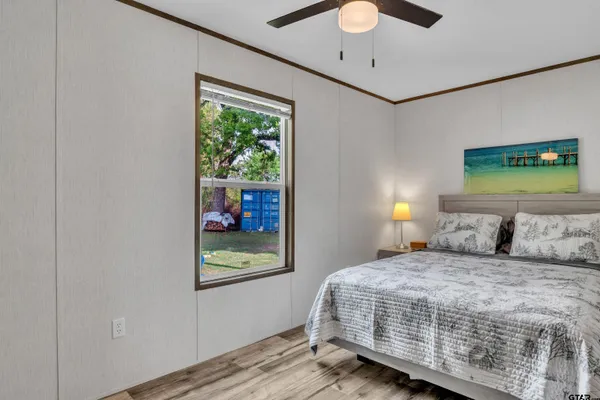 a bedroom with a bed and a chandelier
