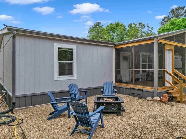 a view of a house with backyard sitting area and garden
