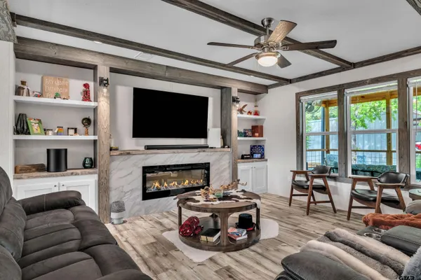 a living room with furniture fireplace and a flat screen tv