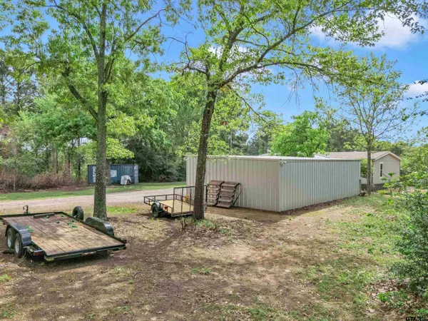 a view of a house with backyard porch and garden