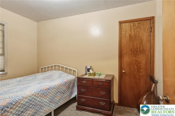 a bed room with a bed and a mirror
