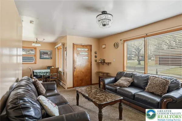 a kitchen with stainless steel appliances granite countertop a sink dishwasher stove a refrigerator with a dining table and chairs