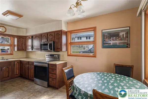 a kitchen with stainless steel appliances a stove sink and cabinets
