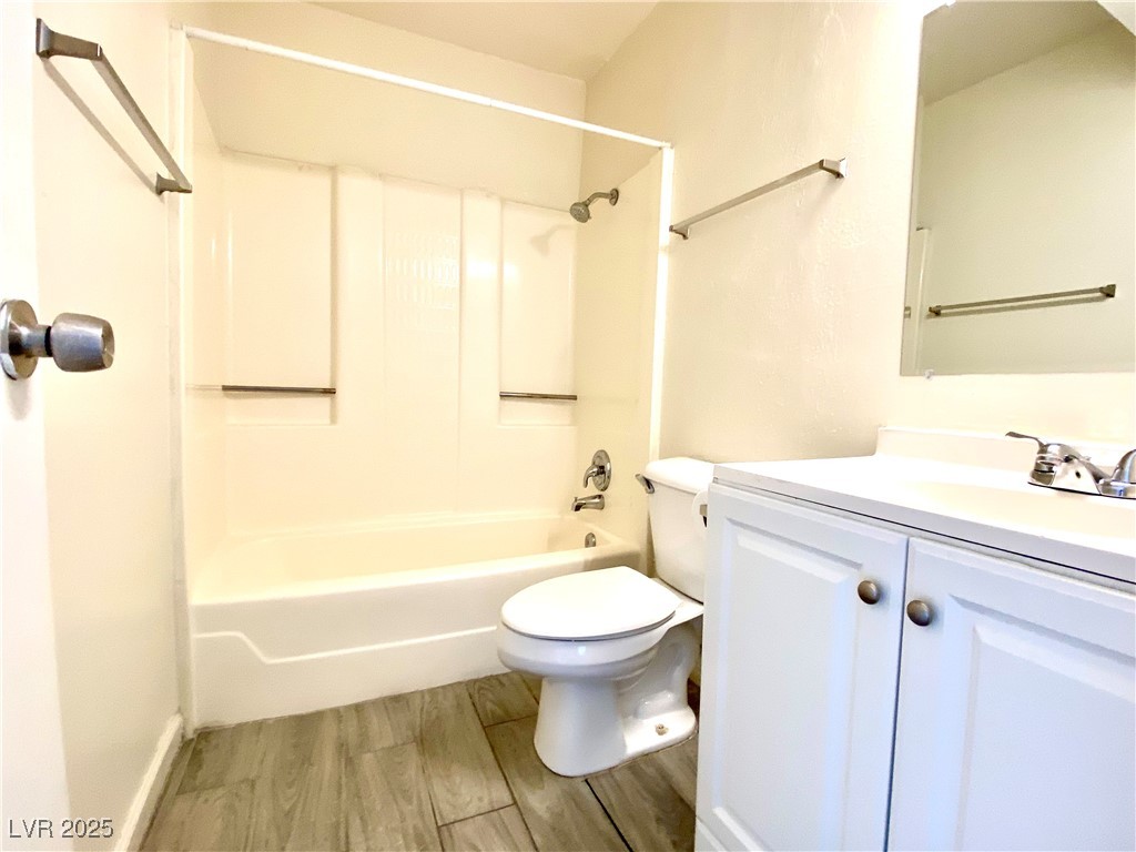 6213 Smoke Ranch Road Las Vegas, NV 89108 - Photo 18 of 22 Bathroom with vanity, wood finished floors, and tub / shower combination