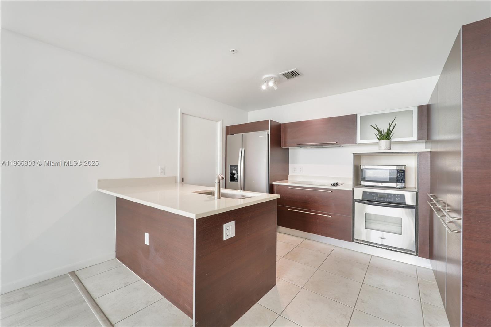 1900 North Bayshore Drive, Unit 4112 Miami, FL 33132 - Photo 11 of 20 a kitchen with stainless steel appliances granite countertop a stove and a sink