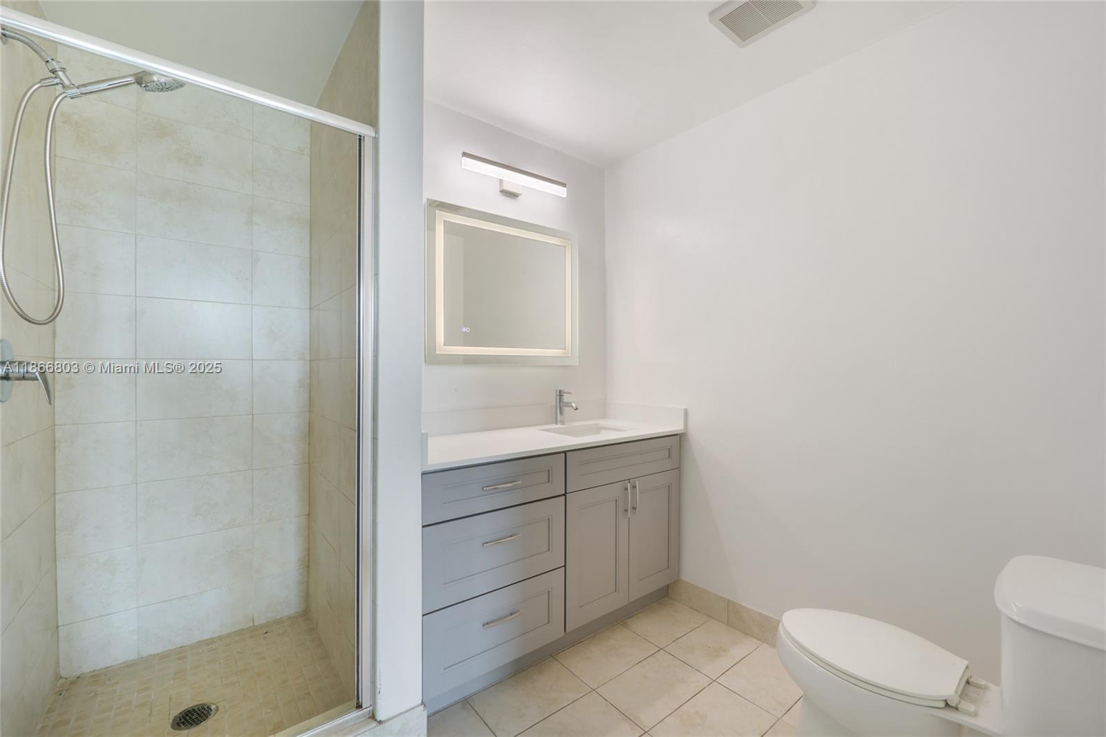 1900 North Bayshore Drive, Unit 4112 Miami, FL 33132 - Photo 13 of 20 a bathroom with a granite countertop sink a toilet and shower