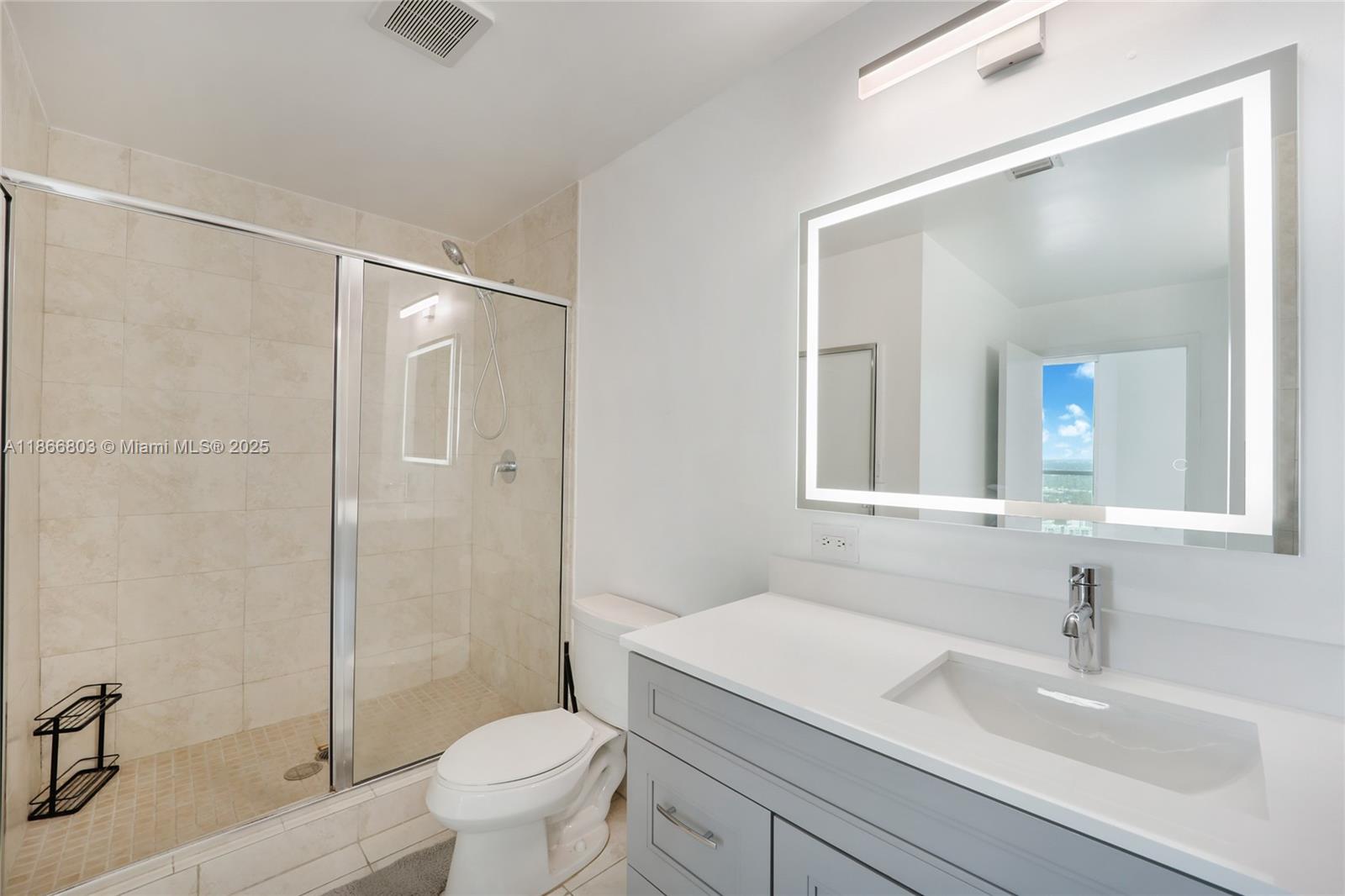 1900 North Bayshore Drive, Unit 4112 Miami, FL 33132 - Photo 14 of 20 a bathroom with a sink a toilet and shower