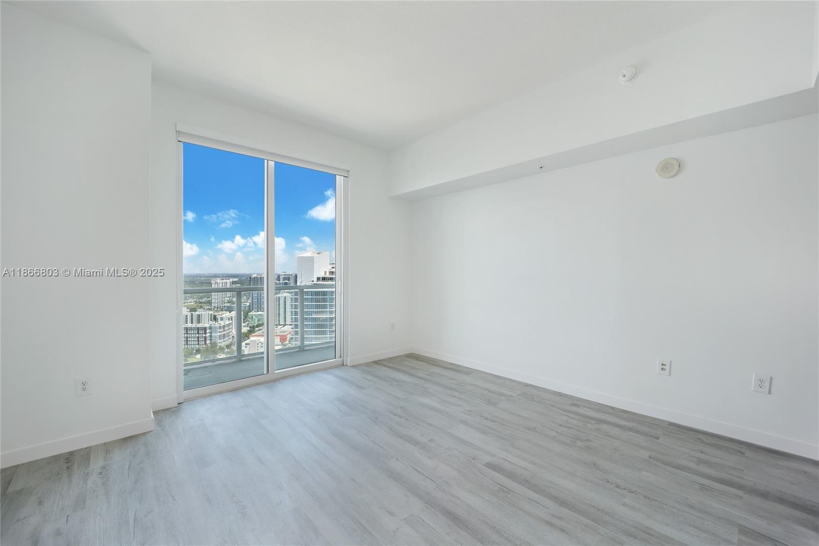 1900 North Bayshore Drive, Unit 4112 Miami, FL 33132 - Photo 17 of 20 wooden floor in an empty room with a window