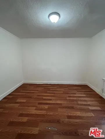 a view of room with wooden floor