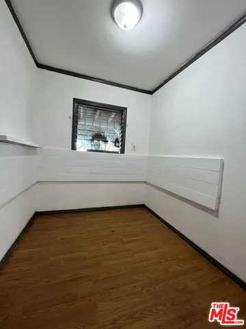 a view of a room with wooden floor and window