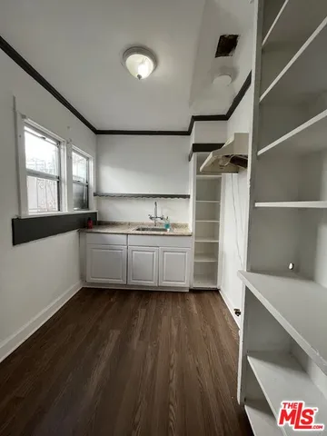 a kitchen with a cabinets and wooden floor