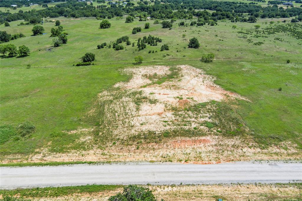 316 Kilkenny Road Poolville, TX 76487 - Photo 2 of 20 a view of a yard with a wooden fence