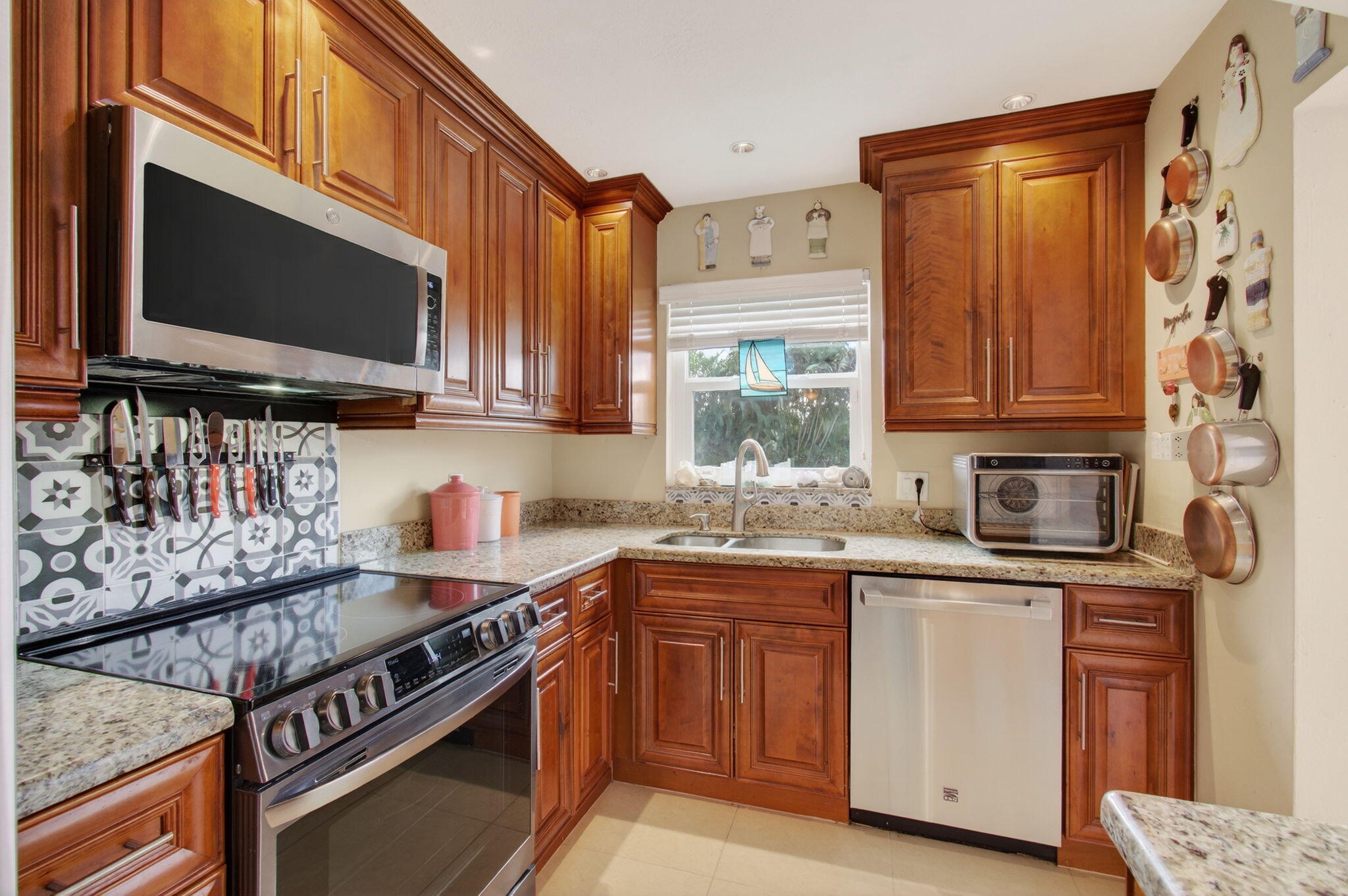 1060 Old Boynton Road Boynton Beach, FL 33426 - Photo 13 of 47 a kitchen with stainless steel appliances stove microwave and cabinets