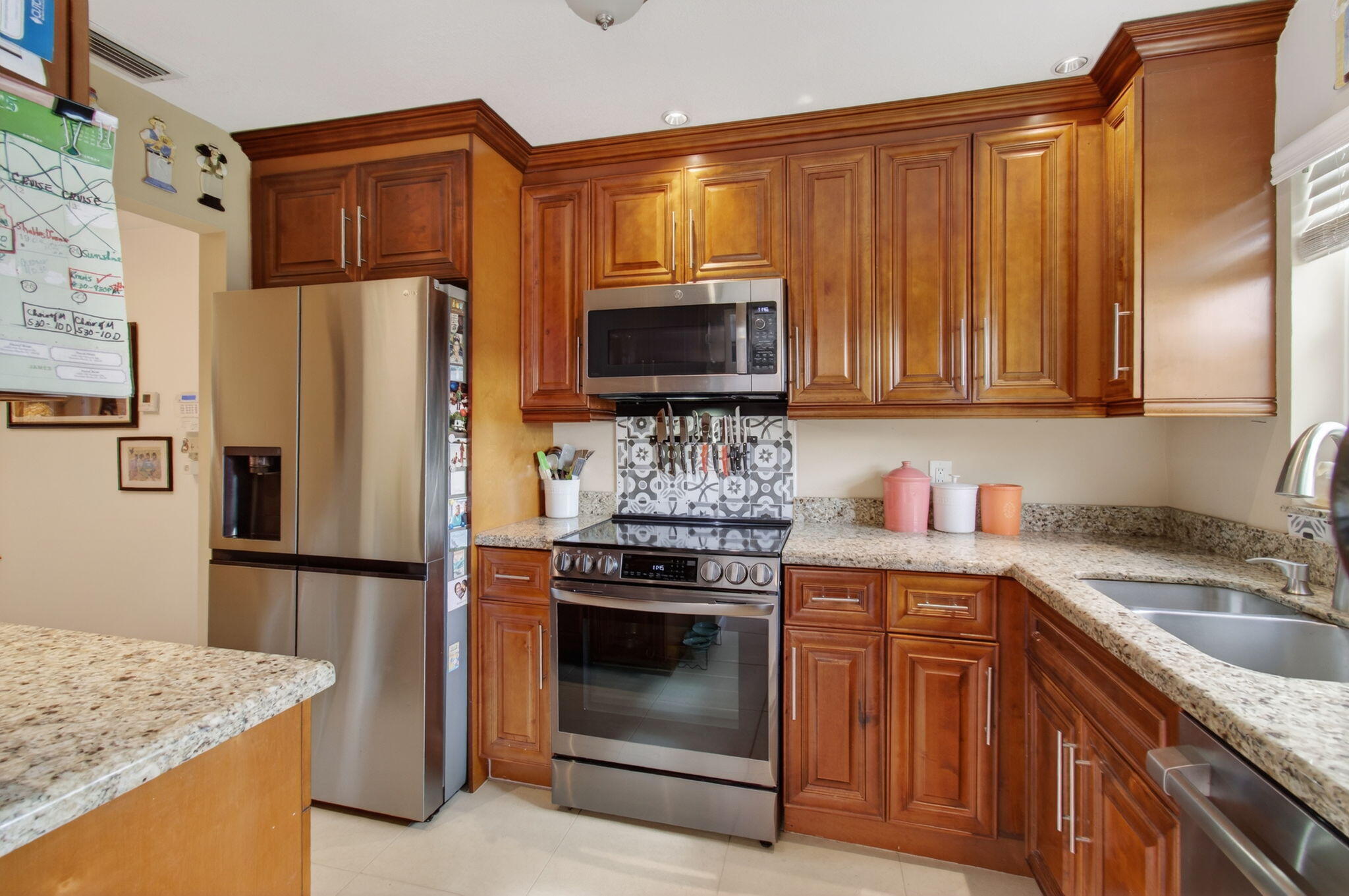 1060 Old Boynton Road Boynton Beach, FL 33426 - Photo 14 of 47 a kitchen with granite countertop a stove top oven microwave and refrigerator