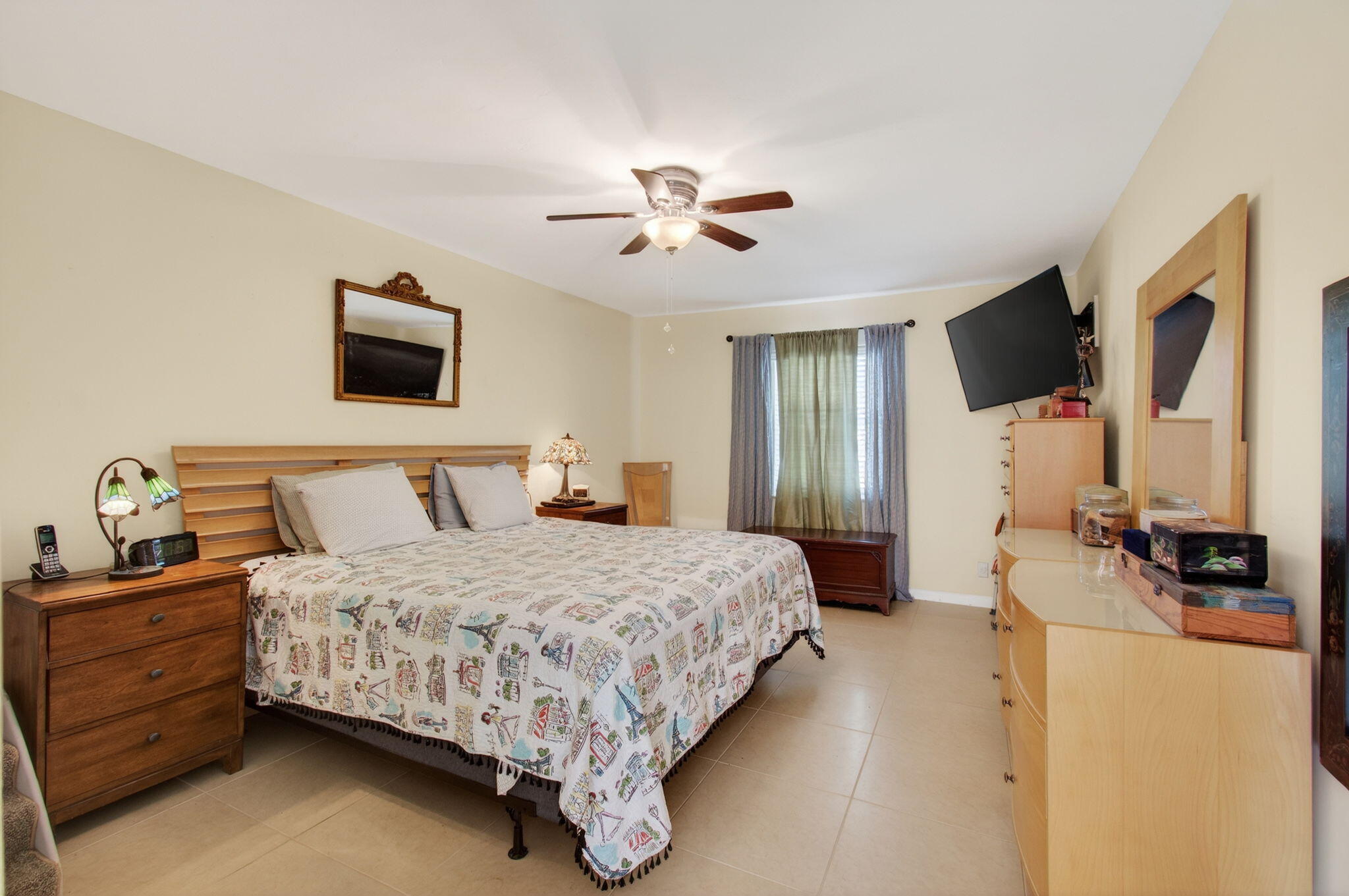 1060 Old Boynton Road Boynton Beach, FL 33426 - Photo 19 of 47 a bedroom with a bed a couch and a flat screen tv