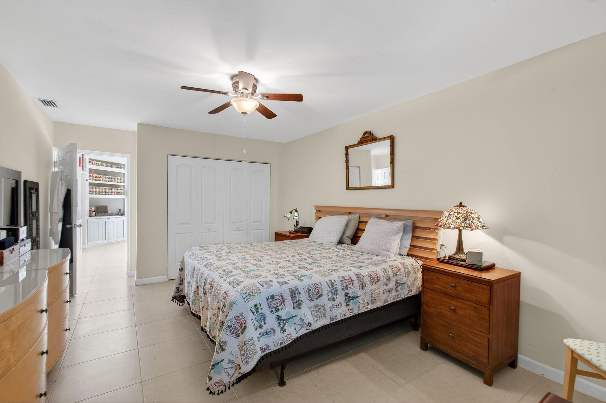 1060 Old Boynton Road Boynton Beach, FL 33426 - Photo 20 of 47 a bedroom with a bed and a chandelier