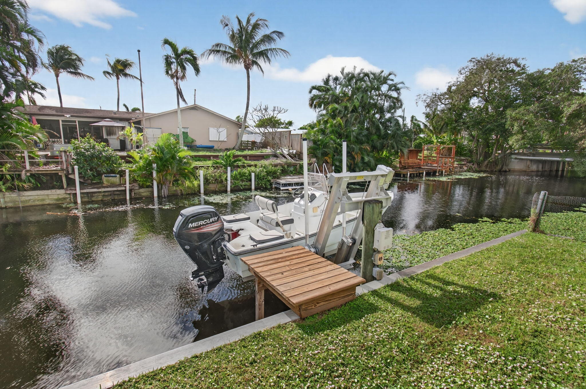 1060 Old Boynton Road Boynton Beach, FL 33426 - Photo 2 of 47 a view of a wooden deck with chairs and a yard