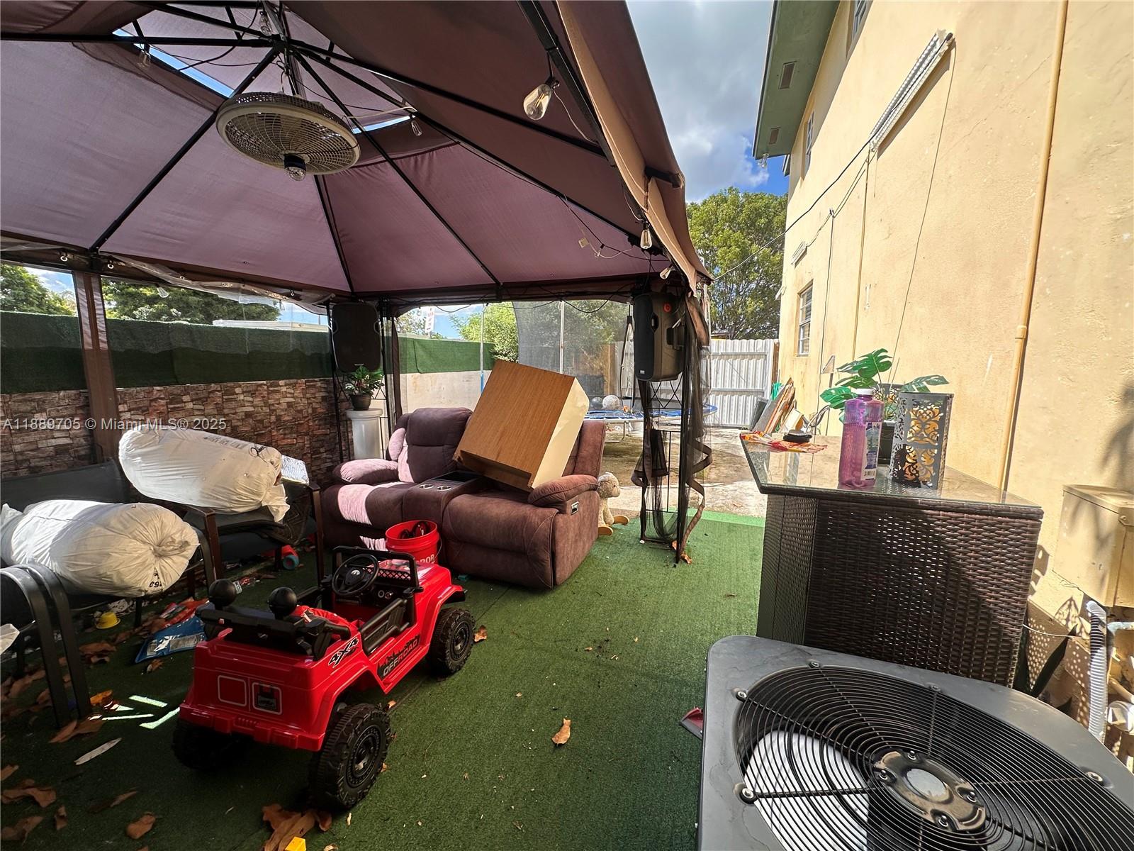 16901 Northwest 51st Place, Unit C Miami Gardens, FL 33055 - Photo 11 of 13 a patio with table and chairs