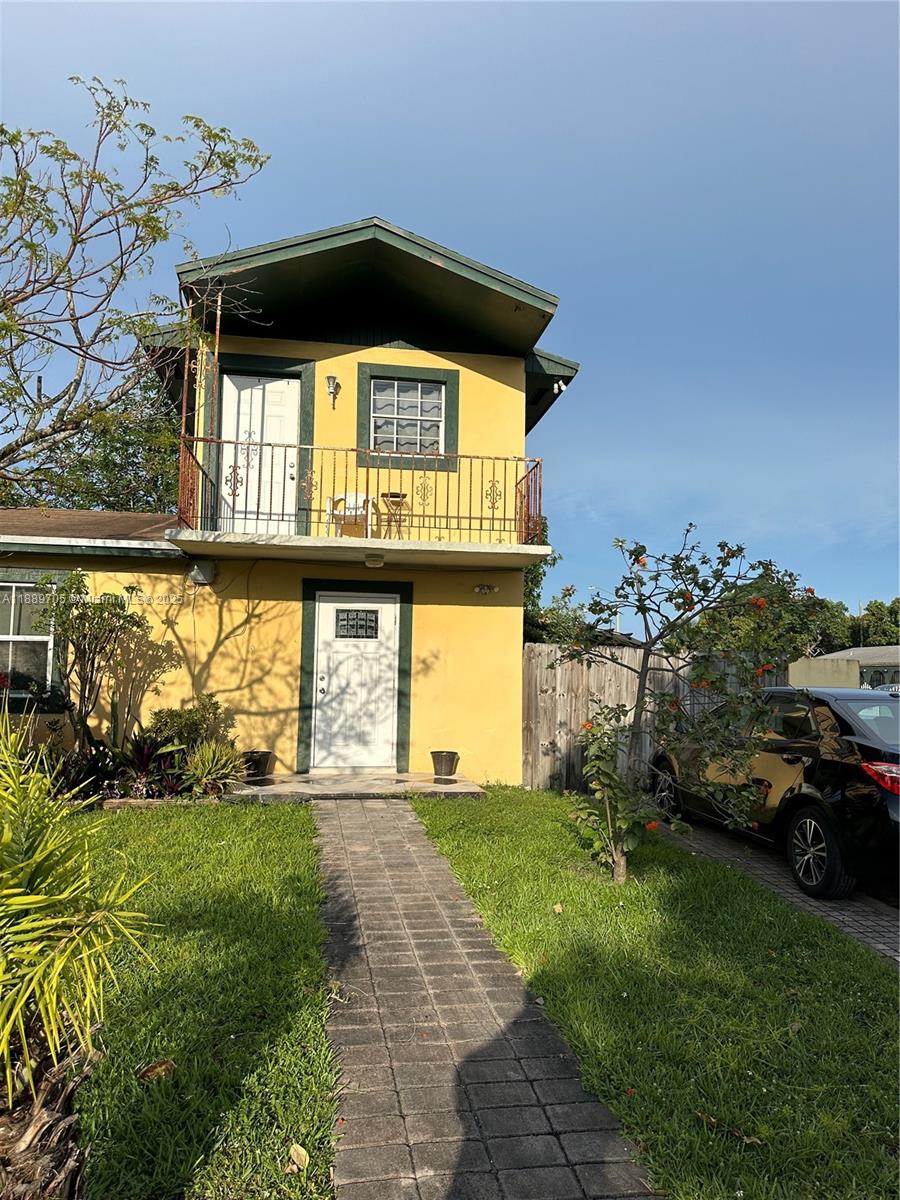 16901 Northwest 51st Place, Unit C Miami Gardens, FL 33055 - Photo 2 of 13 a front view of a house with a yard