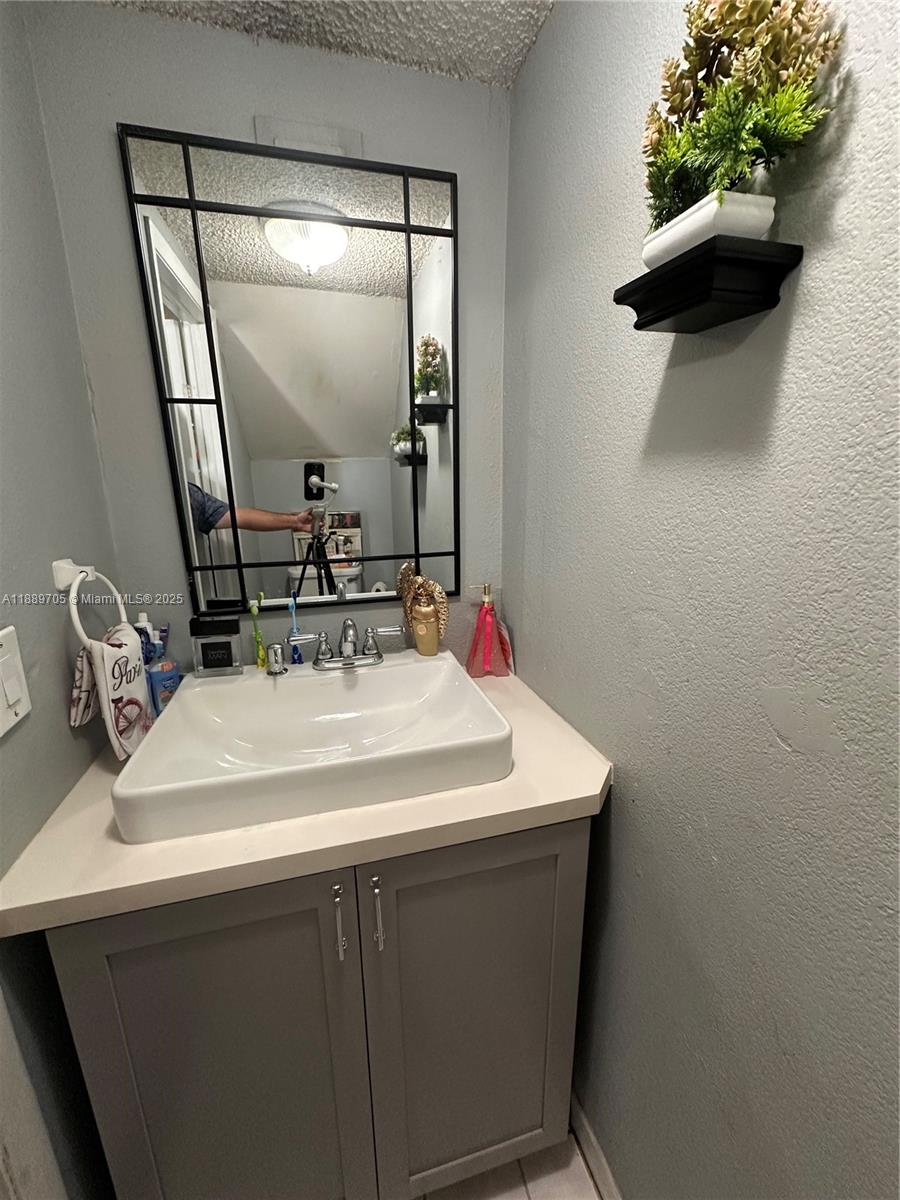 16901 Northwest 51st Place, Unit C Miami Gardens, FL 33055 - Photo 6 of 13 a bathroom with a sink and a mirror