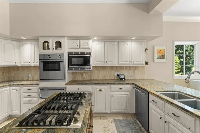 a dining room with furniture a chandelier and window