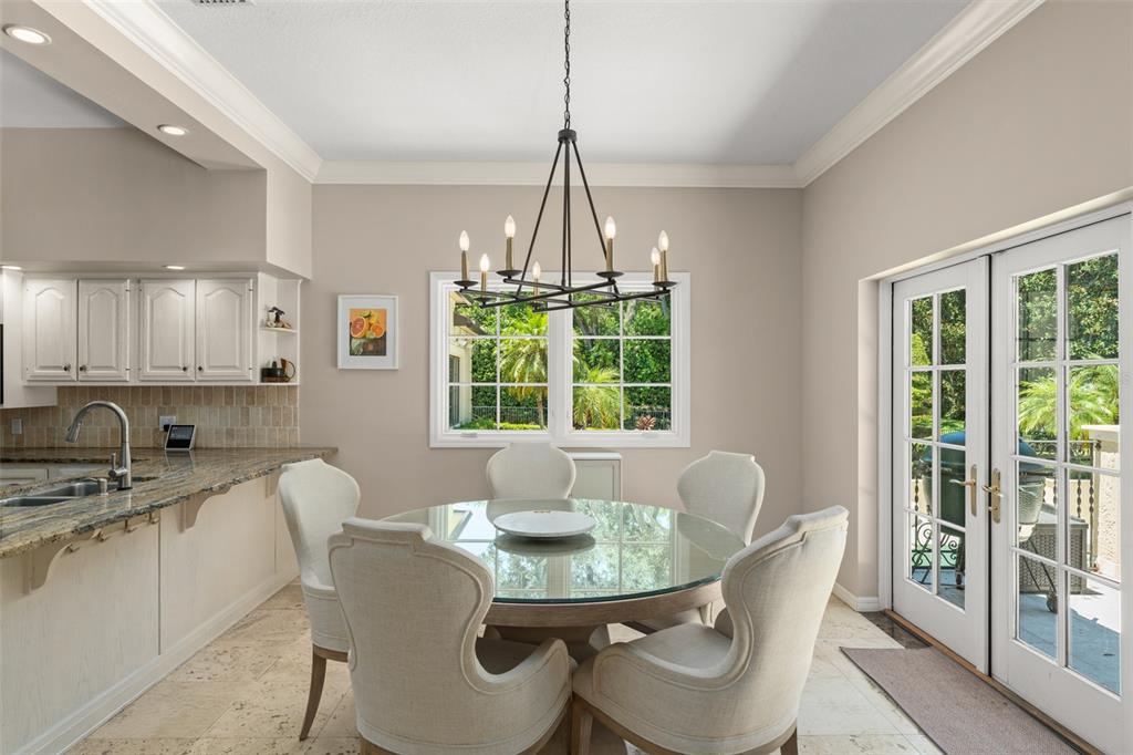 9731 Chestnut Ridge Drive Windermere, FL 34786 - Photo 18 of 57 a dining room with furniture a chandelier and window