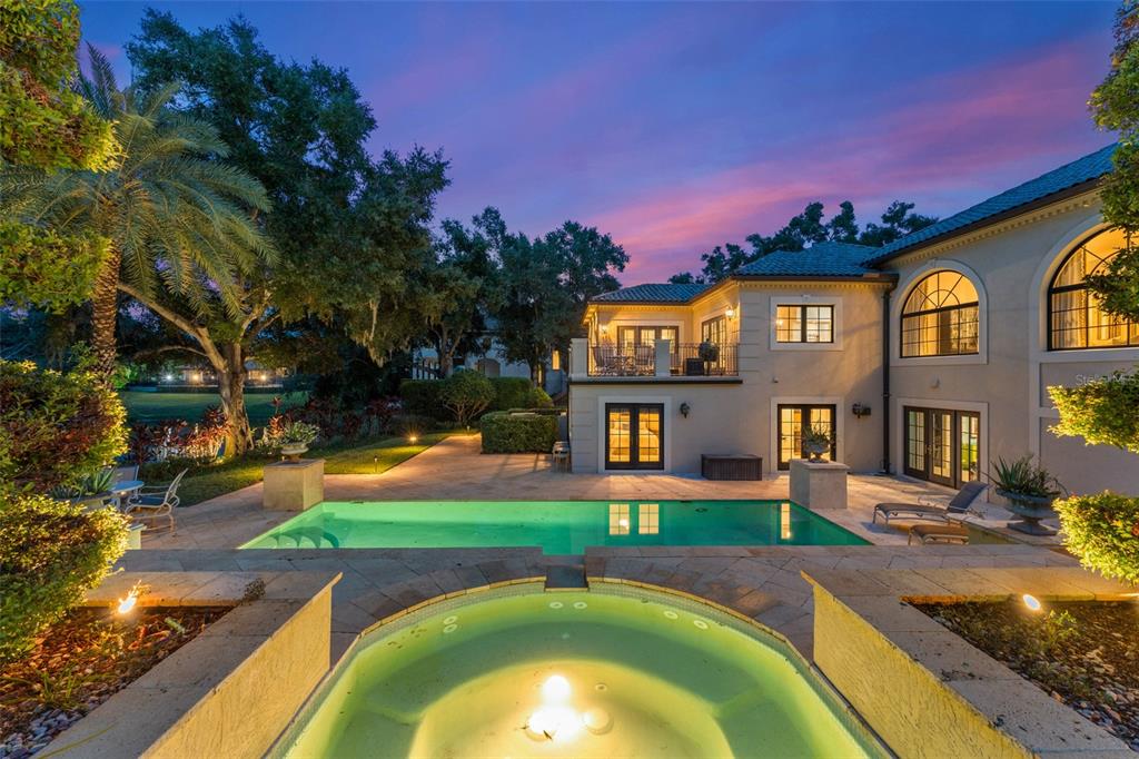 9731 Chestnut Ridge Drive Windermere, FL 34786 - Photo 2 of 57 a swimming pool with outdoor seating yard and yard