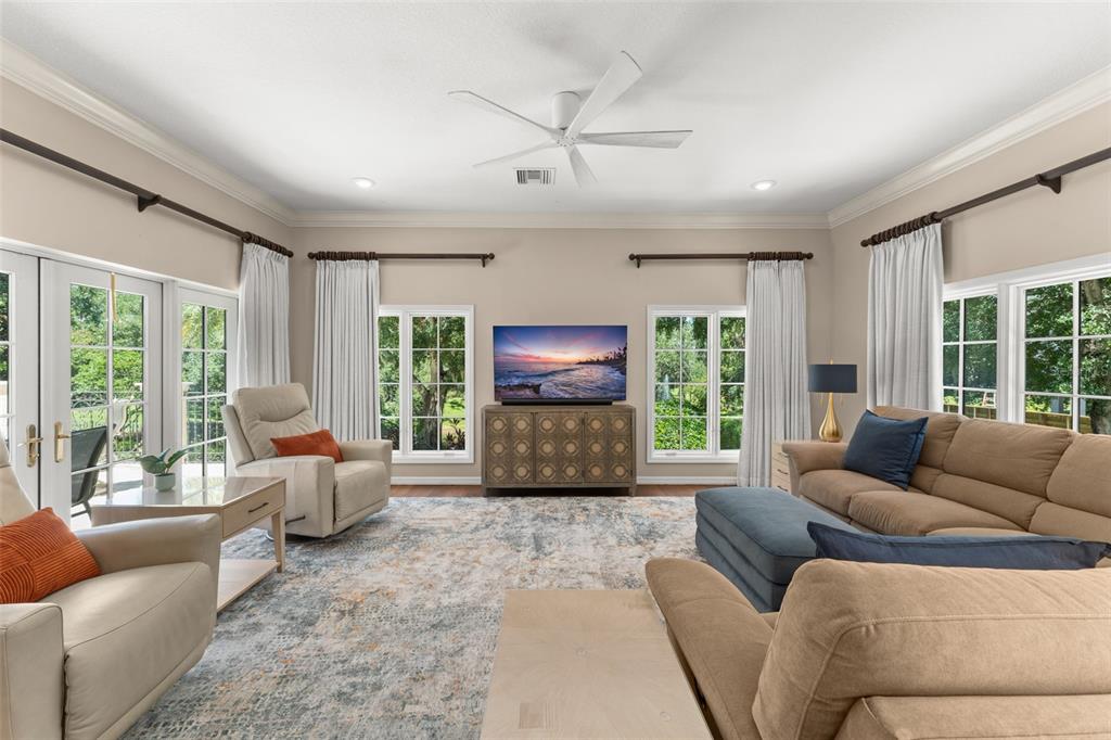 9731 Chestnut Ridge Drive Windermere, FL 34786 - Photo 21 of 57 a living room with furniture and large windows
