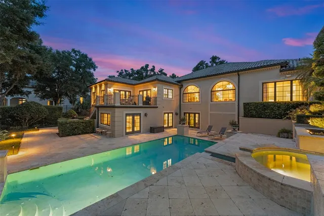 a view of a house with a swimming pool and a yard