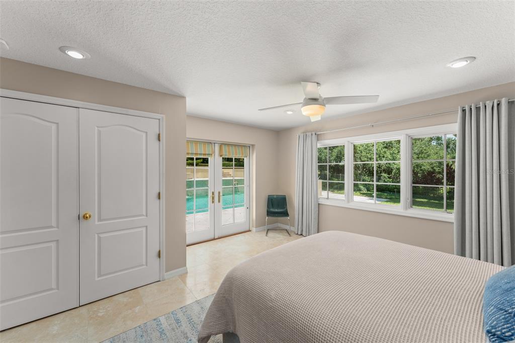 9731 Chestnut Ridge Drive Windermere, FL 34786 - Photo 33 of 57 a bedroom with a large bed and a large window