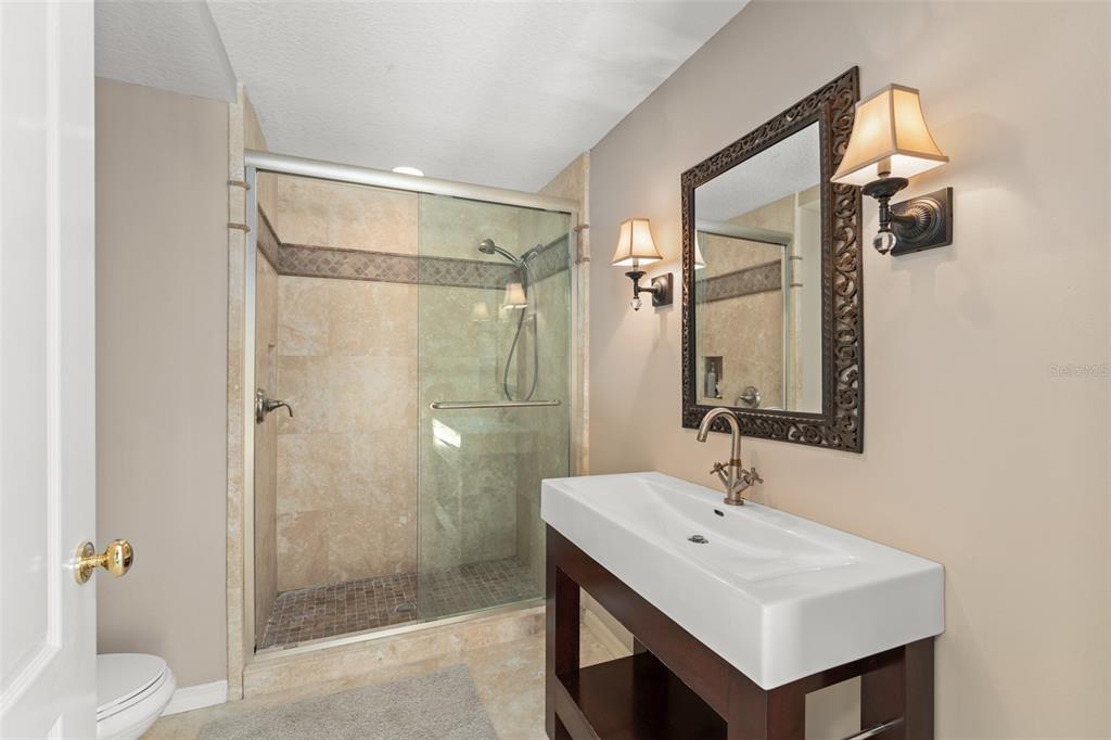 9731 Chestnut Ridge Drive Windermere, FL 34786 - Photo 38 of 57 a bathroom with a sink toilet and shower