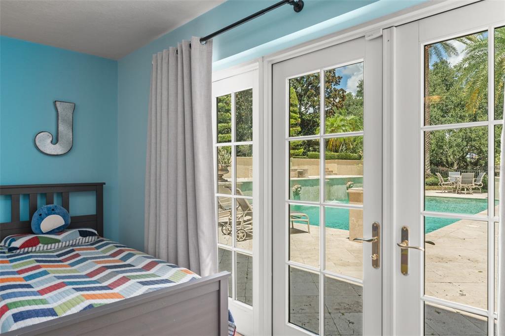 9731 Chestnut Ridge Drive Windermere, FL 34786 - Photo 41 of 57 a bedroom with a bed and wooden floor