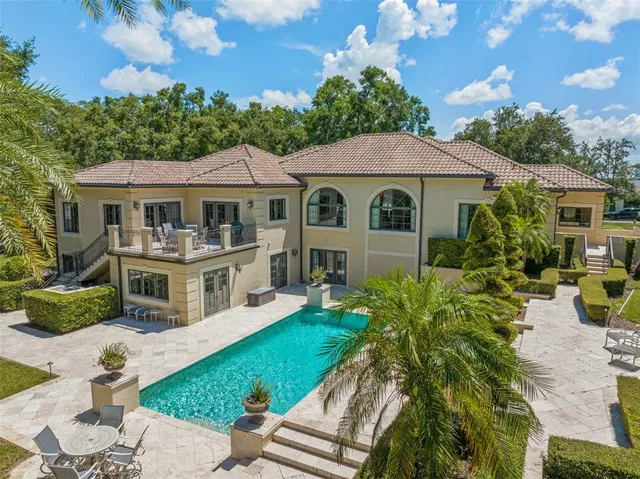 a view of a garden with large trees