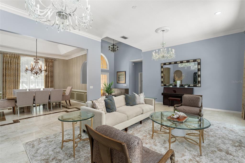 9731 Chestnut Ridge Drive Windermere, FL 34786 - Photo 9 of 57 a living room with furniture and a chandelier