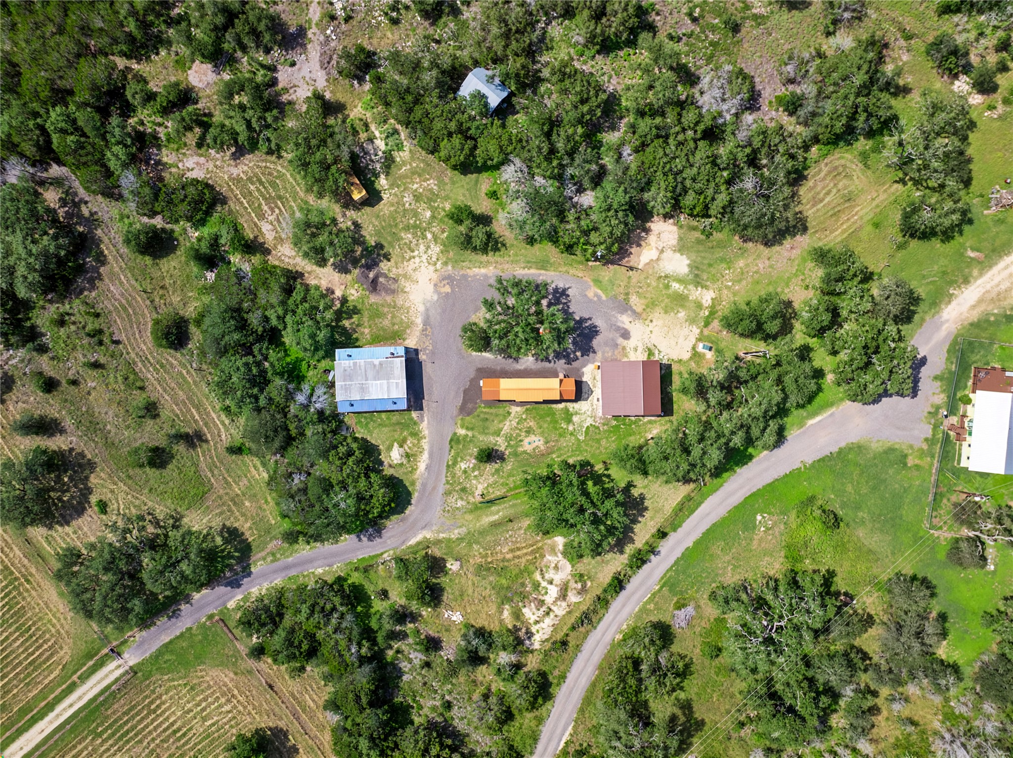 8200 Ranch Road 12 San Marcos, TX 78666 - Photo 24 of 40 An aerial perspective reveals a vast rural property featuring multiple structures amidst natural landscapes.