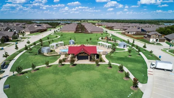 an aerial view of a house with a garden and lake view