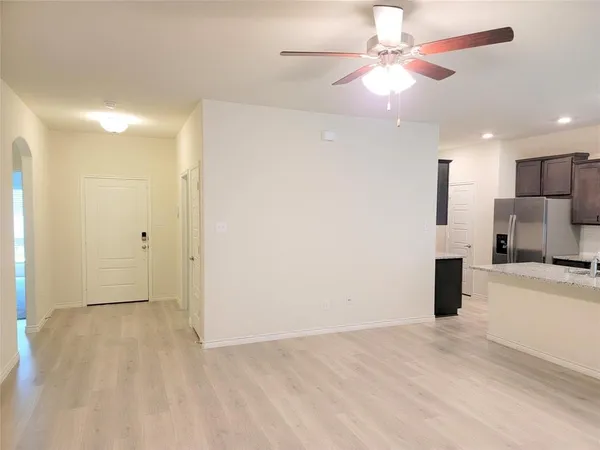 a view of a kitchen with a sink and a refrigerator