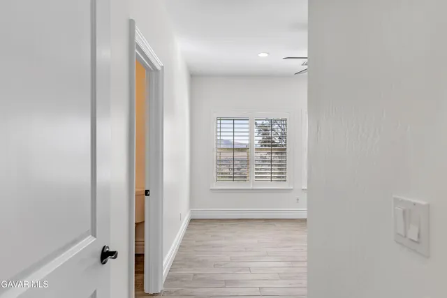 a bathroom with a granite countertop sink a toilet and mirror