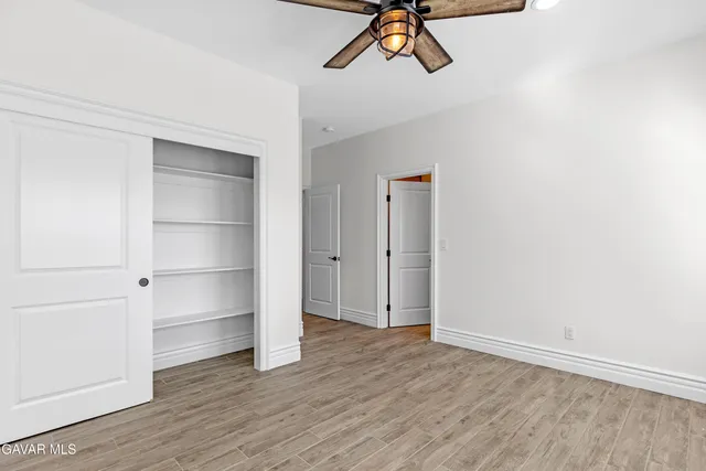 a bathroom with a granite countertop sink a mirror and shower