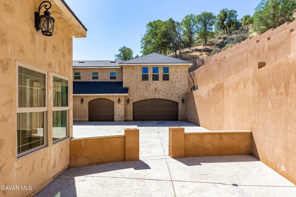 a view of a house with backyard sitting area and swimming pool